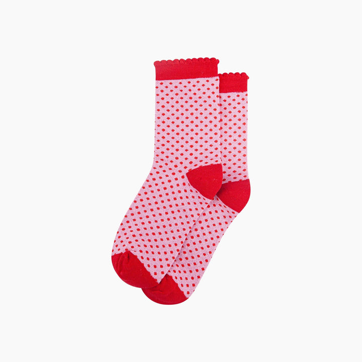 Pink crew socks with red polka dots, scalloped cuff, and red heel and toe