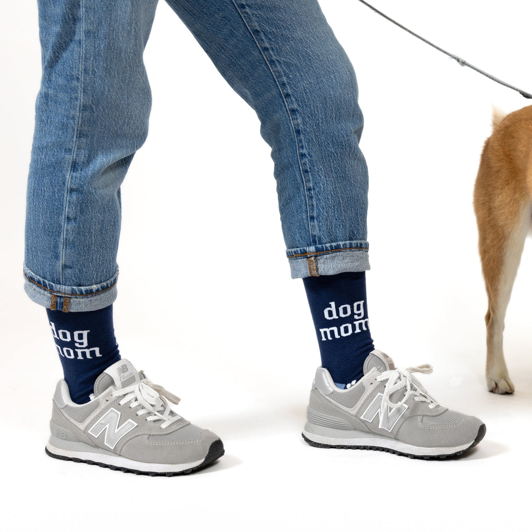 Navy blue crew socks with white 'dog mom' text worn with jeans and sneakers