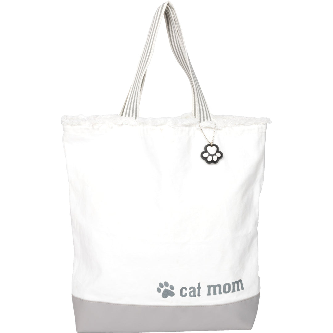 White canvas tote bag with gray bottom featuring cat mom text and paw print charm