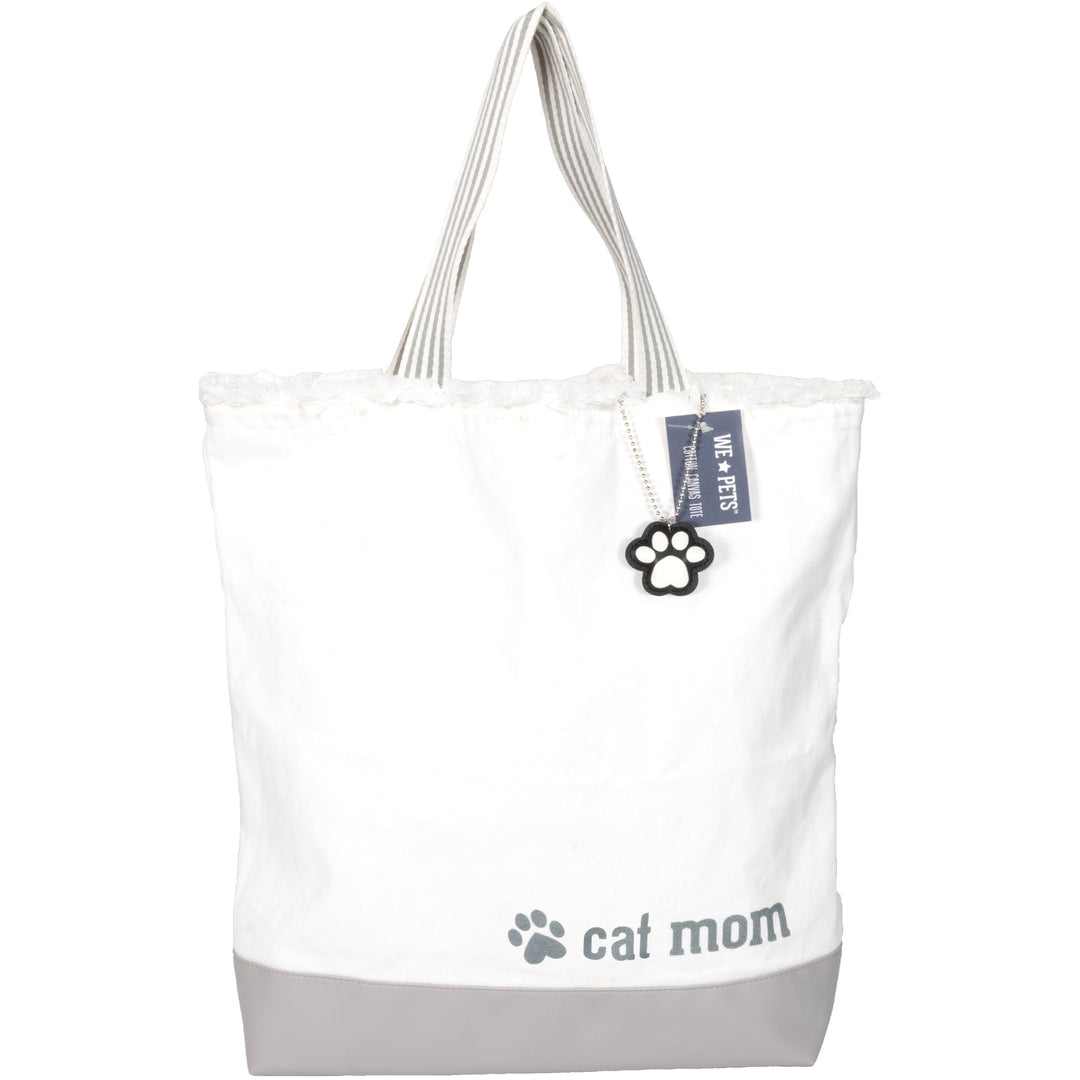 White canvas tote bag with gray bottom featuring 'cat mom' text and paw print charm