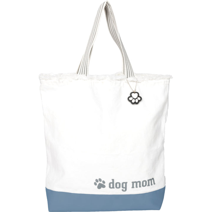 White canvas tote bag with blue bottom, 'dog mom' text and paw print charm