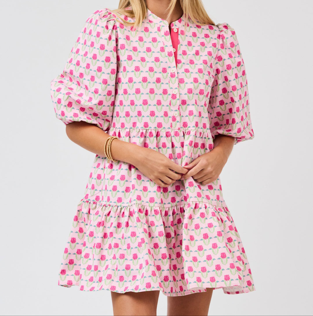 Pink floral mini dress with puff sleeves, button front, and tiered ruffle hem