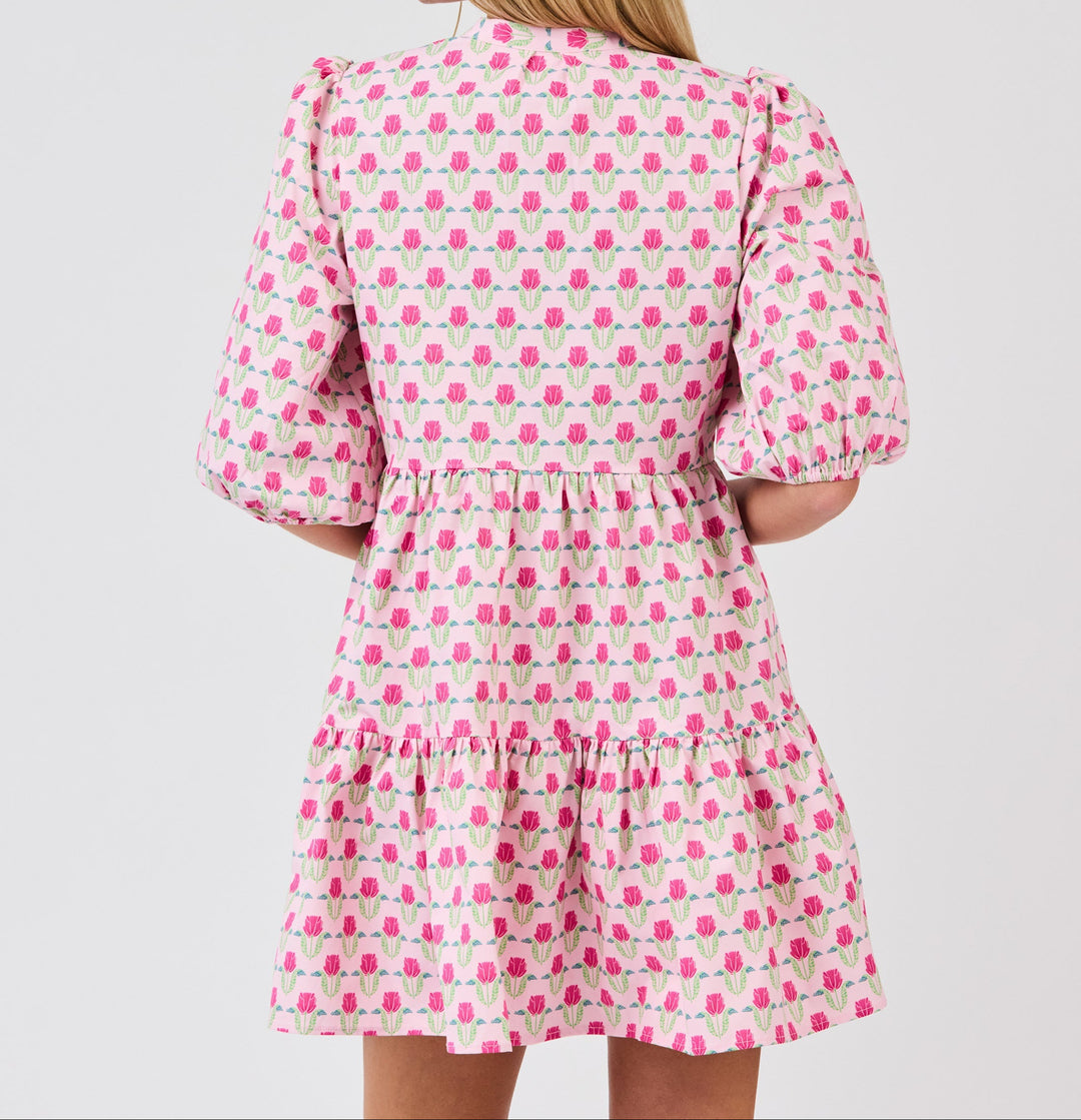 Pink floral mini dress with puffed sleeves and tiered ruffle hem, back view