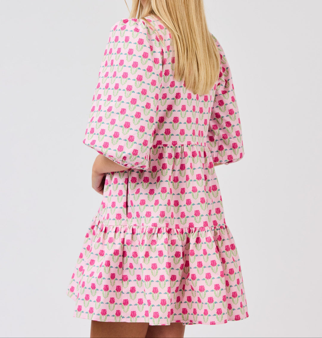Pink floral mini dress with ruffled sleeves and tiered skirt featuring tulip print