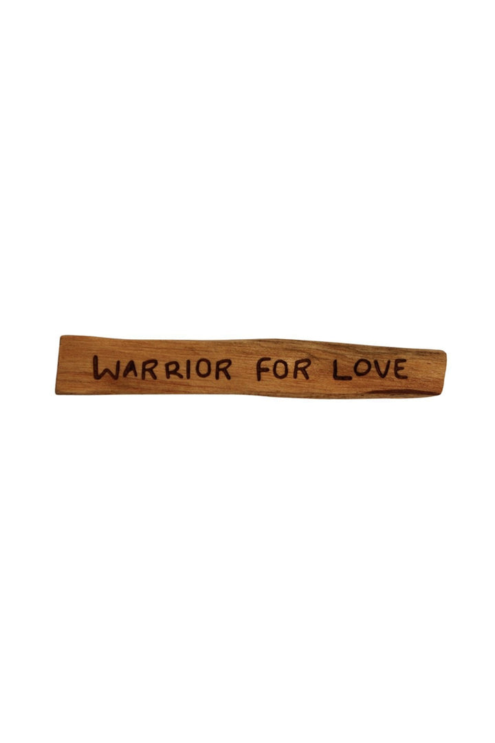 Sugarboo palo santo wood stick engraved with mantra 'Warrior For Love' on white background