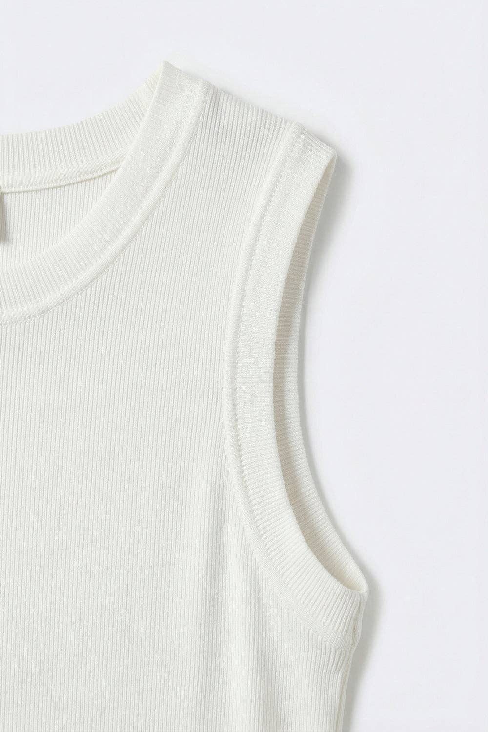 White ribbed knit tank top with crew neckline shown in detail on clean background