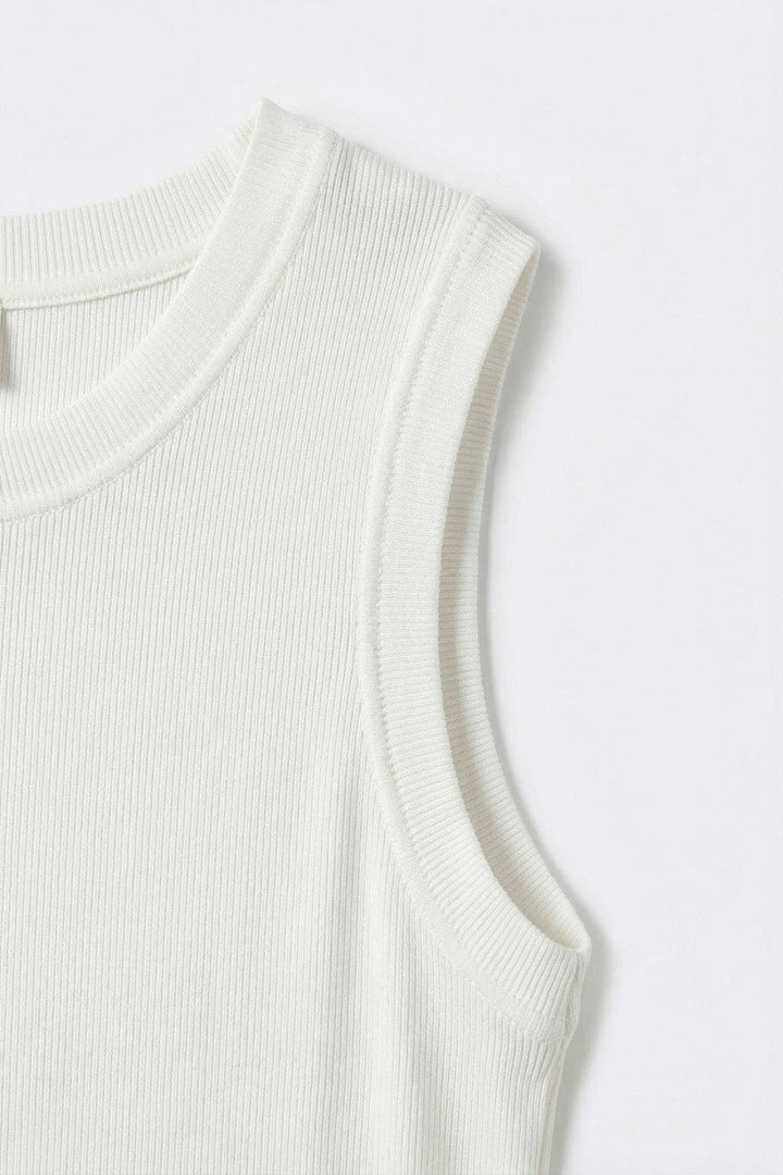 White ribbed knit tank top with crew neckline shown in detail on clean background