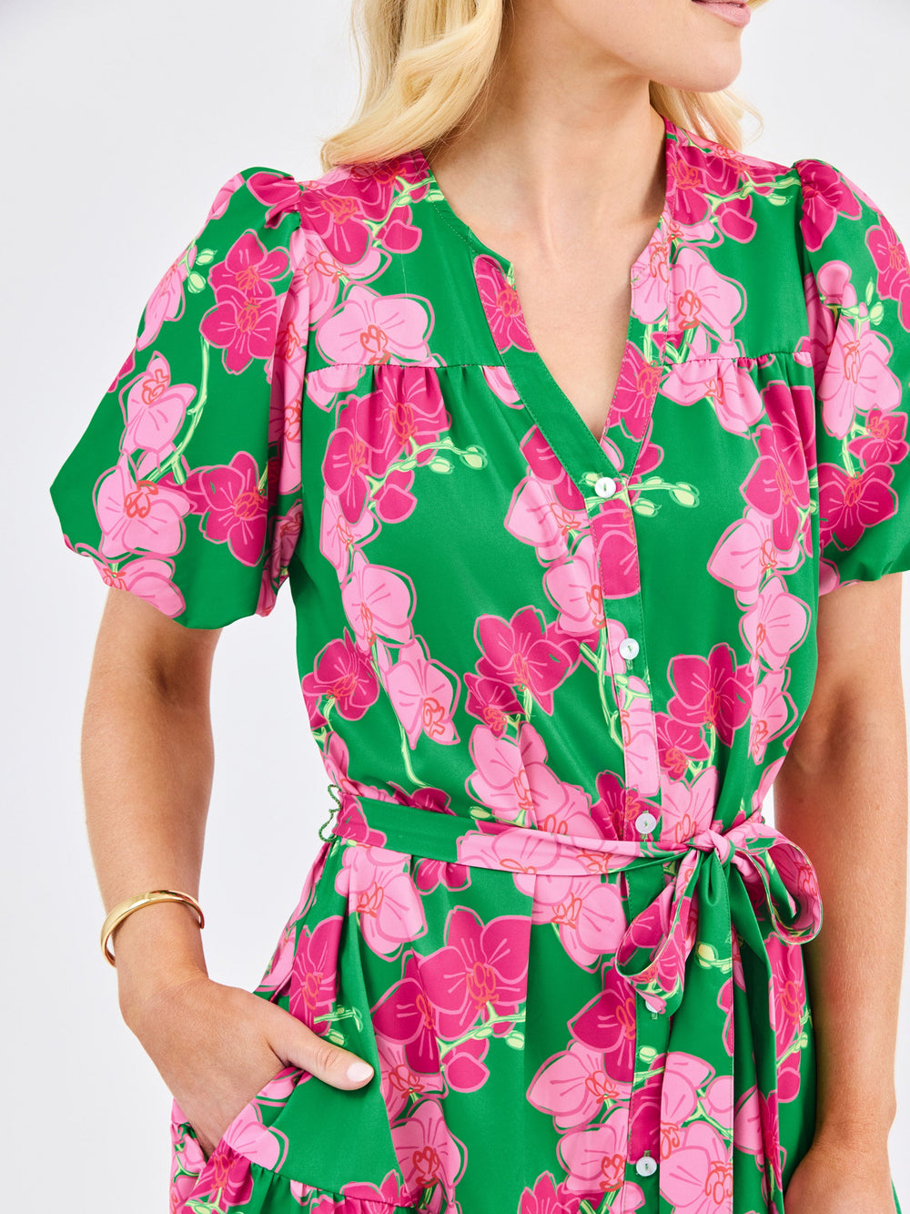 Green dress with pink orchid floral print, short sleeves, button front, tie waist
