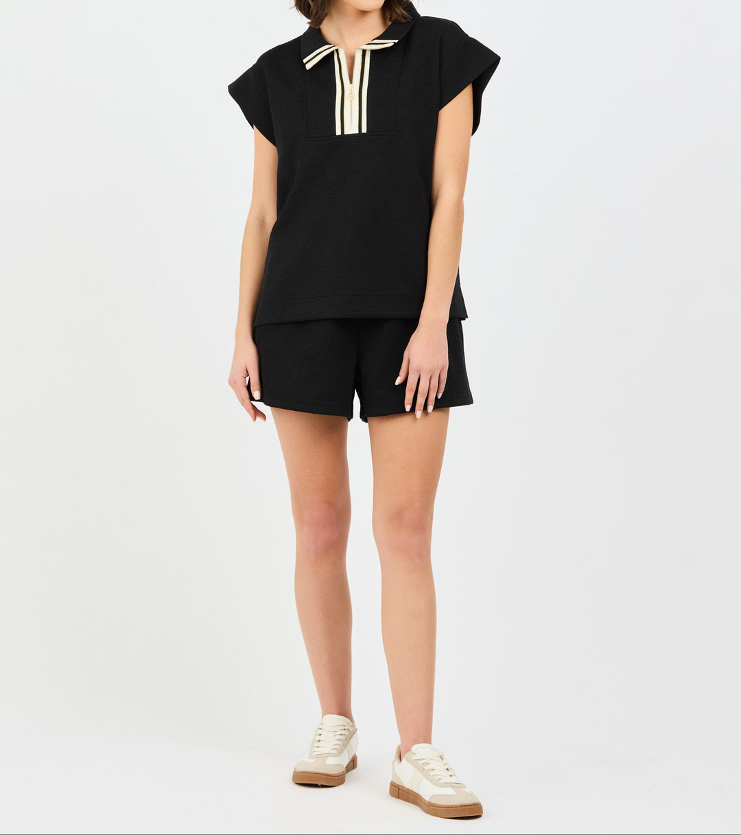 Black two-piece Porter Set by Mary Square featuring short-sleeve top with white trim and matching shorts