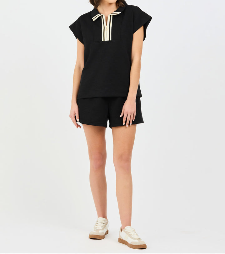Black two-piece Porter Set by Mary Square featuring short-sleeve top with white trim and matching shorts