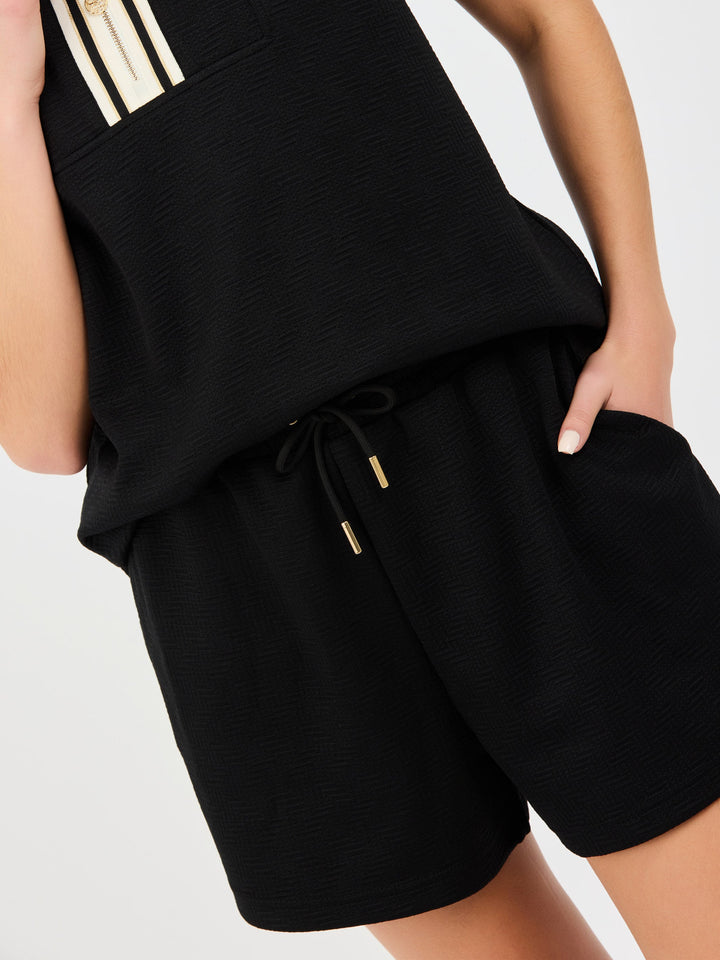Black Porter set with sleeveless top featuring gold accents and matching shorts with drawstring waist