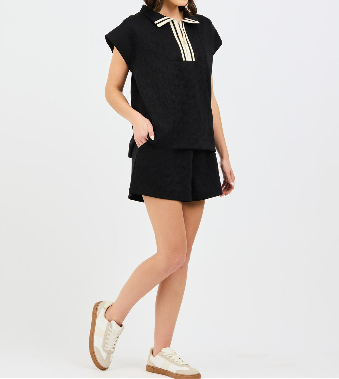 Black two-piece set with cap sleeve top featuring white collar trim and matching shorts