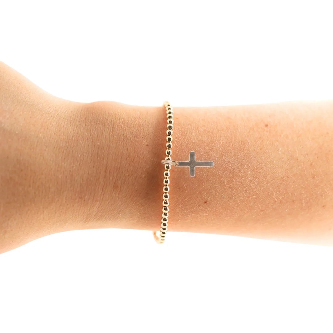 Beaded Blondes Mini Cross Charm Bracelet with gold beads and cross pendant worn on wrist