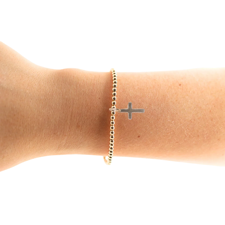 Beaded Blondes Mini Cross Charm Bracelet with gold beads and cross pendant worn on wrist