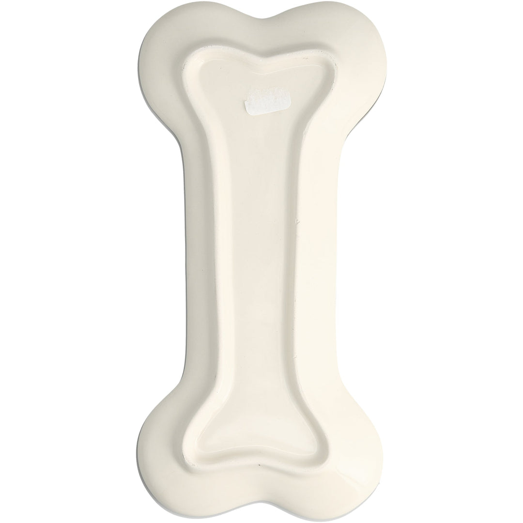 Bone-colored ceramic dog bone shaped spoon rest with raised center ridge