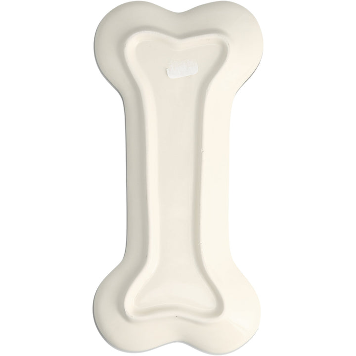 Bone-colored ceramic dog bone shaped spoon rest with raised center ridge
