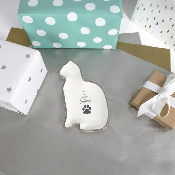 White cat-shaped ceramic spoon rest with paw print and text design by Pavilion