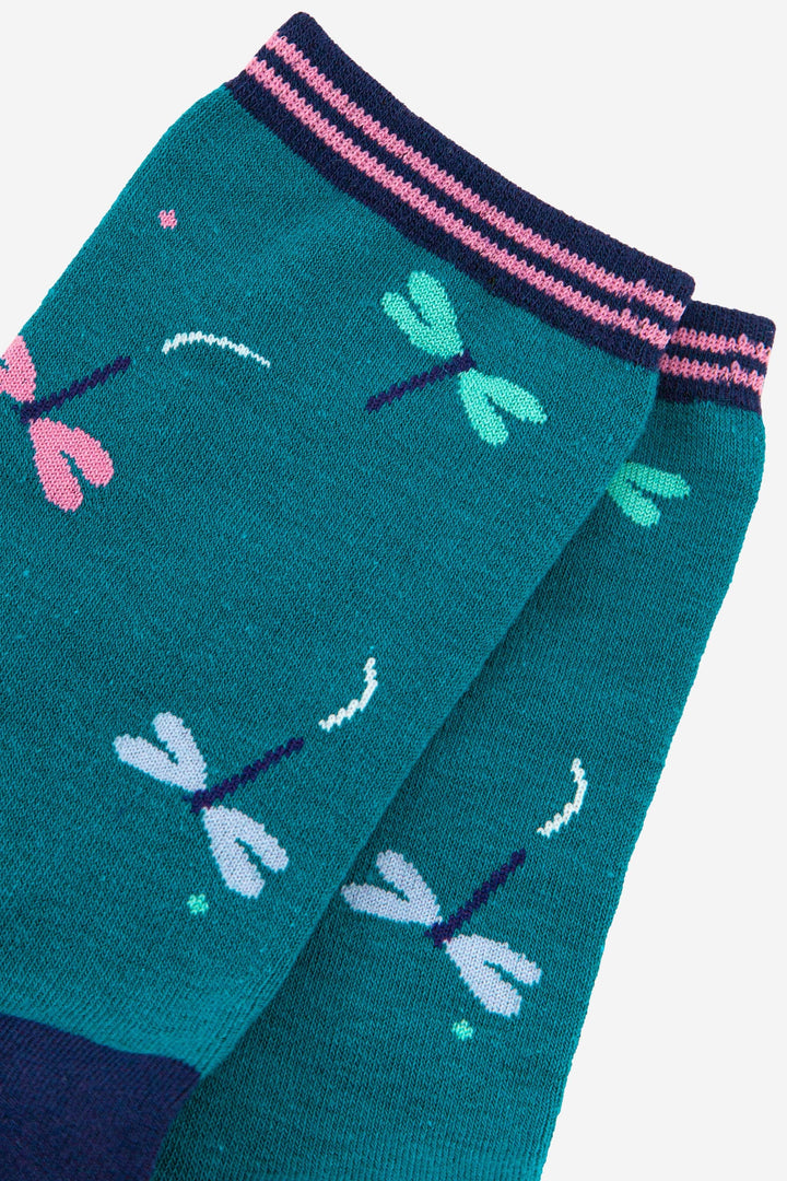Teal bamboo socks with pink, white, and green dragonfly pattern and striped cuff