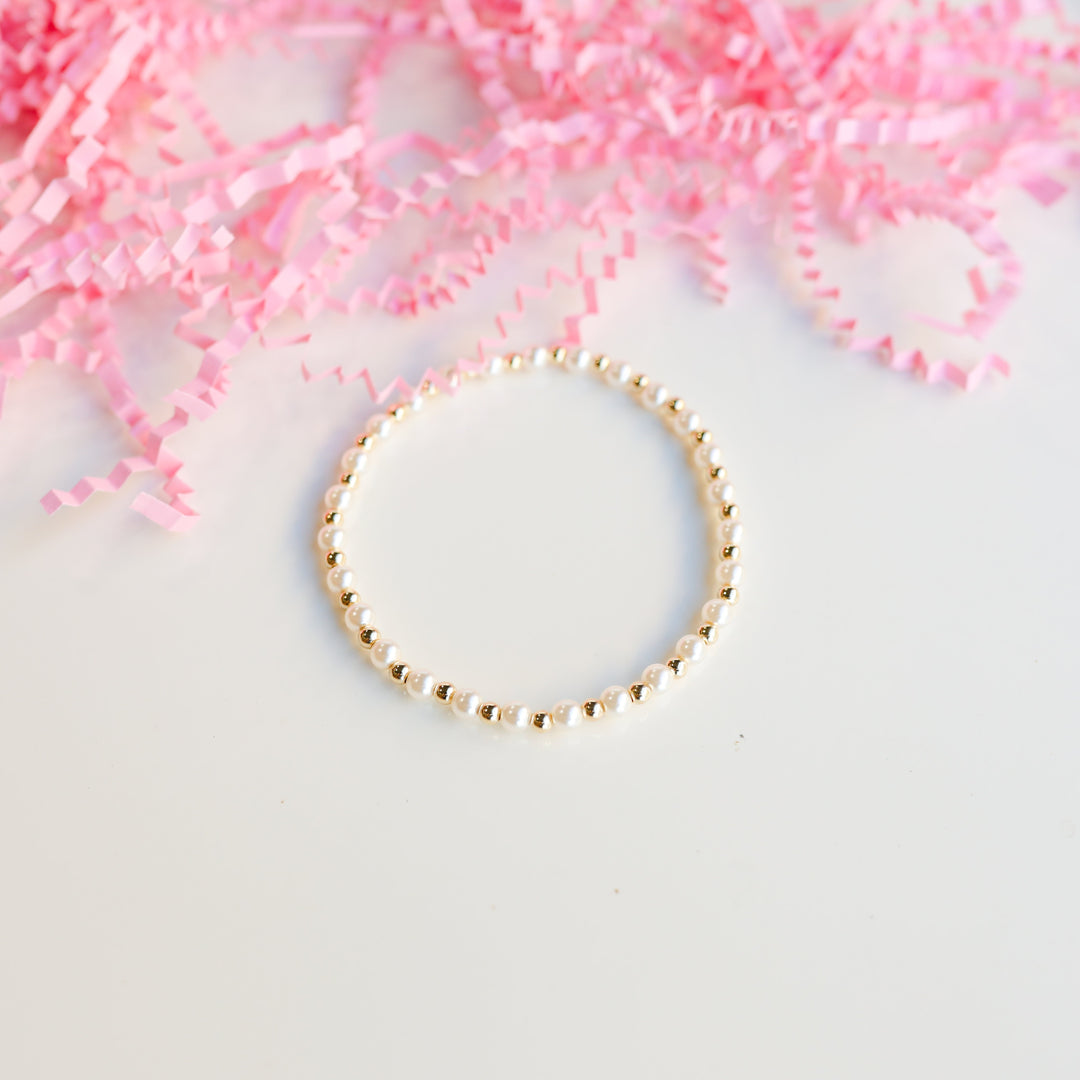 Beaded Blondes Luci Pearl Bracelet alternating white pearl and gold beads on elastic cord