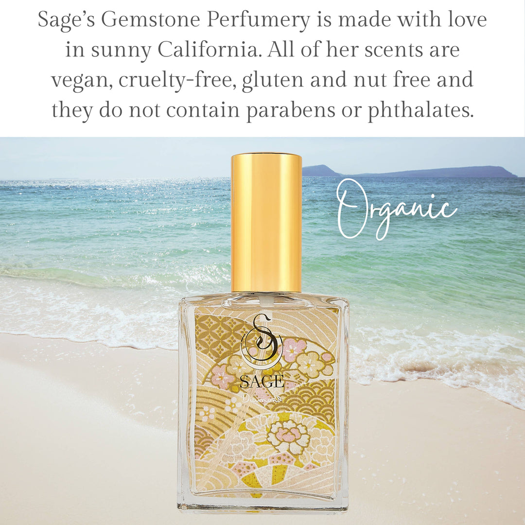 Sage Gemstone Perfumery organic perfume bottle with gold floral pattern on beach background