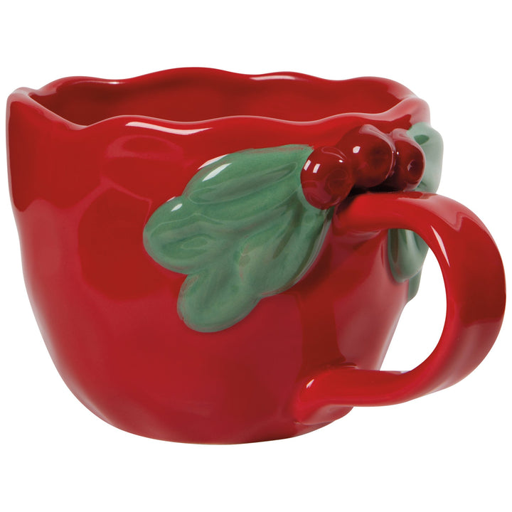 Red ceramic Christmas mug with sculpted holly leaves and berries near handle