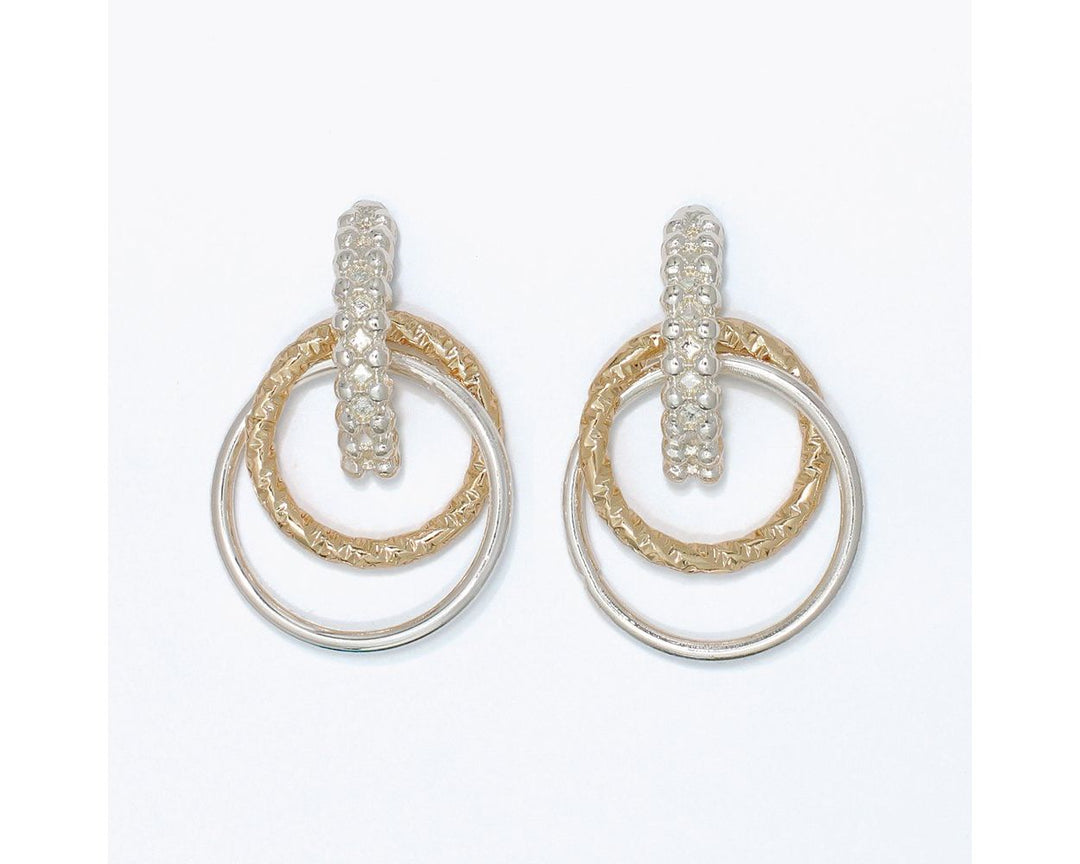 Two-tone drop earrings with textured gold and smooth silver double hoop rings