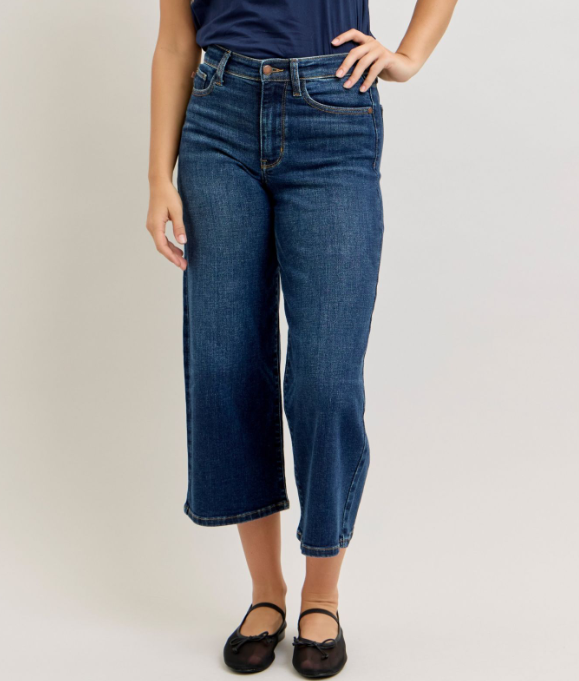 Woman wearing Judy Blue high waisted ankle wide leg jeans in medium wash denim