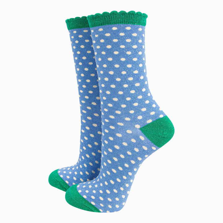 Blue polka dot crew socks with green scalloped cuff, heel, and toe, metallic shimmer