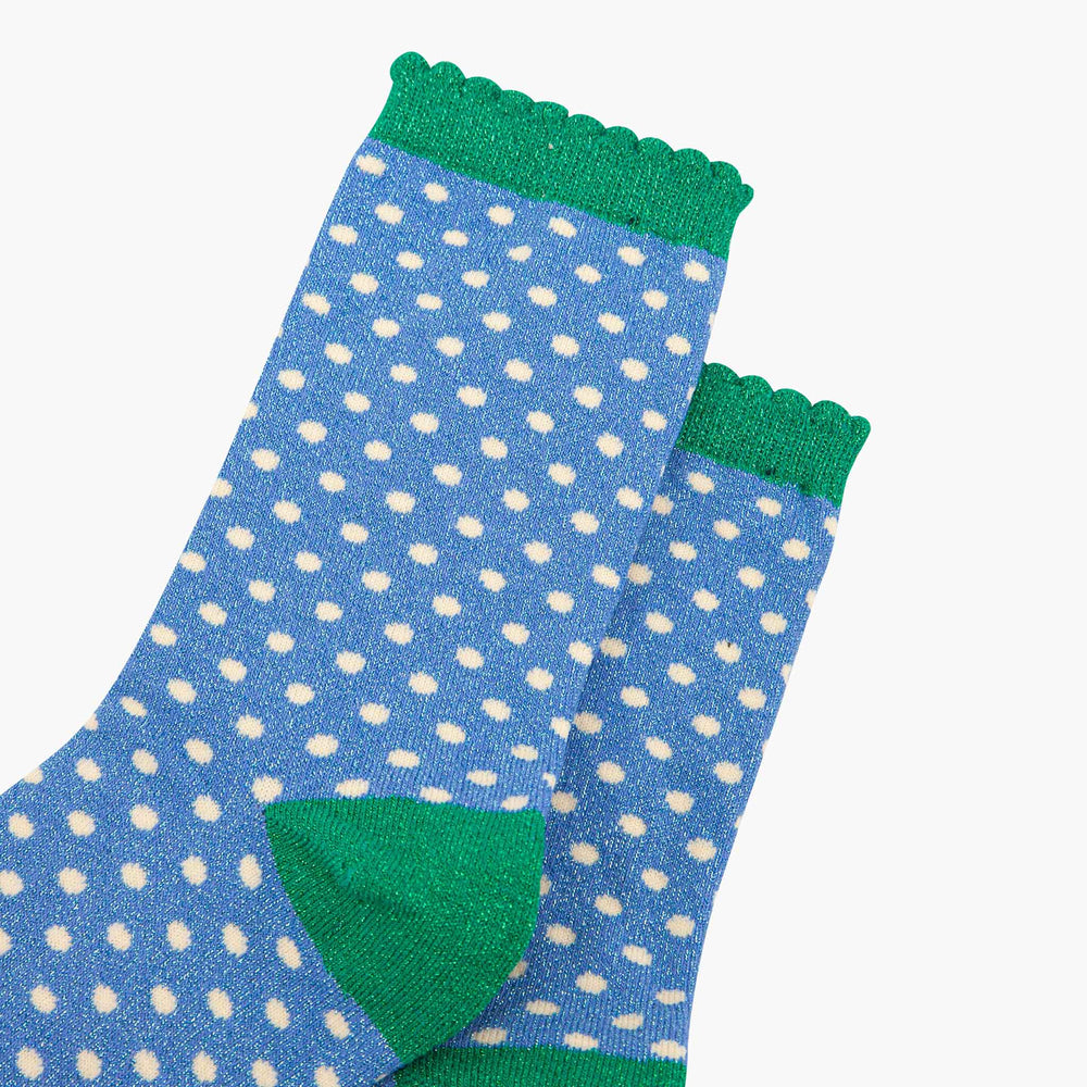 Blue glitter polka dot crew socks with green scalloped cuff and heel accent