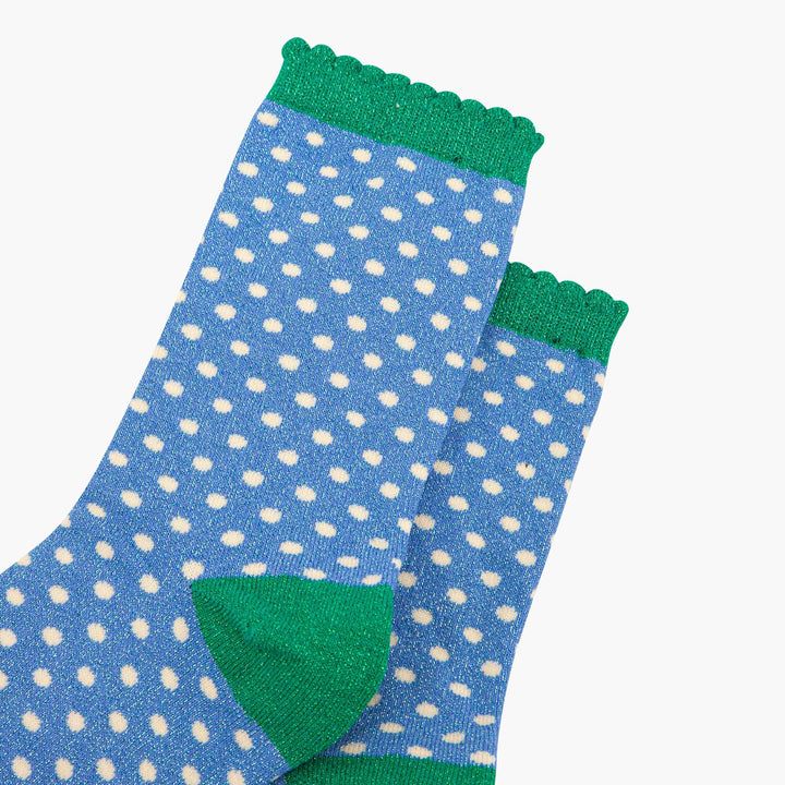 Blue glitter polka dot crew socks with green scalloped cuff and heel accent