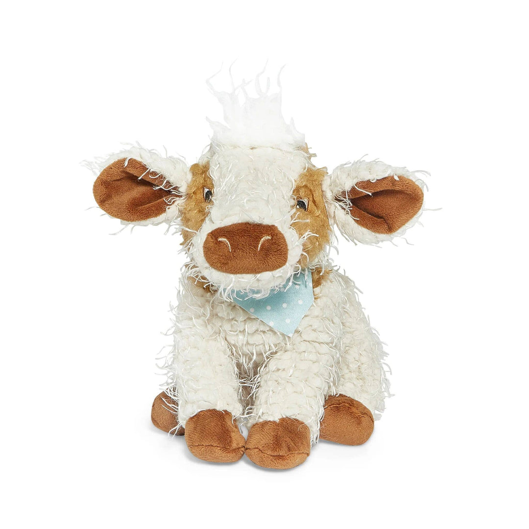 Plush white and brown cow stuffed animal with blue bandana sitting upright