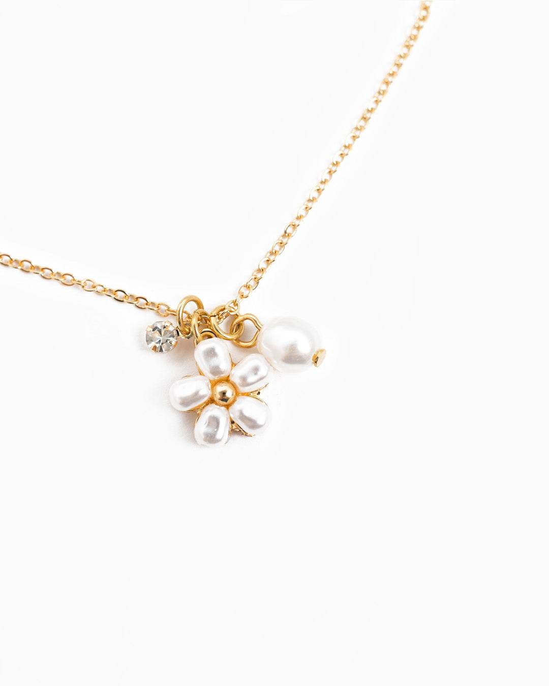 Dainty gold chain necklace with pearl flower charm and crystal accent pendant