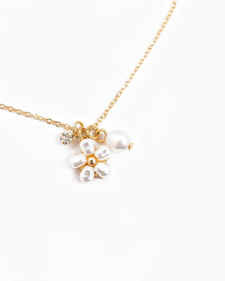 Dainty gold chain necklace with pearl flower charm and crystal accent pendant