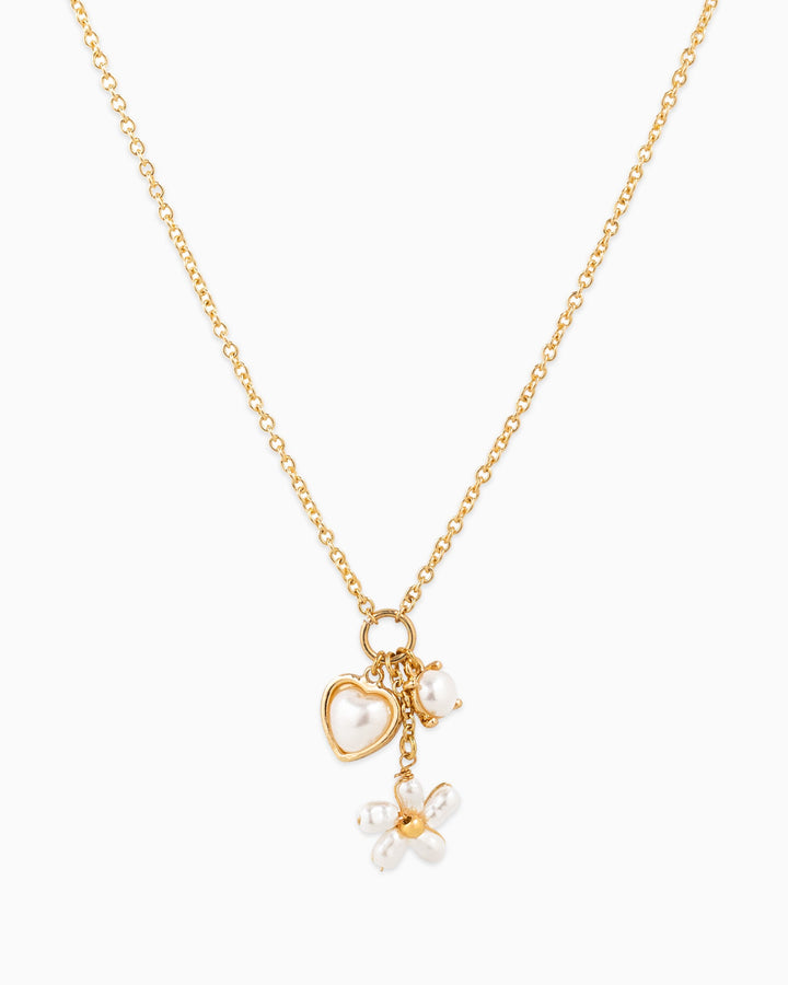 Gold chain necklace with pearl heart, single pearl, and pearl flower charm pendants