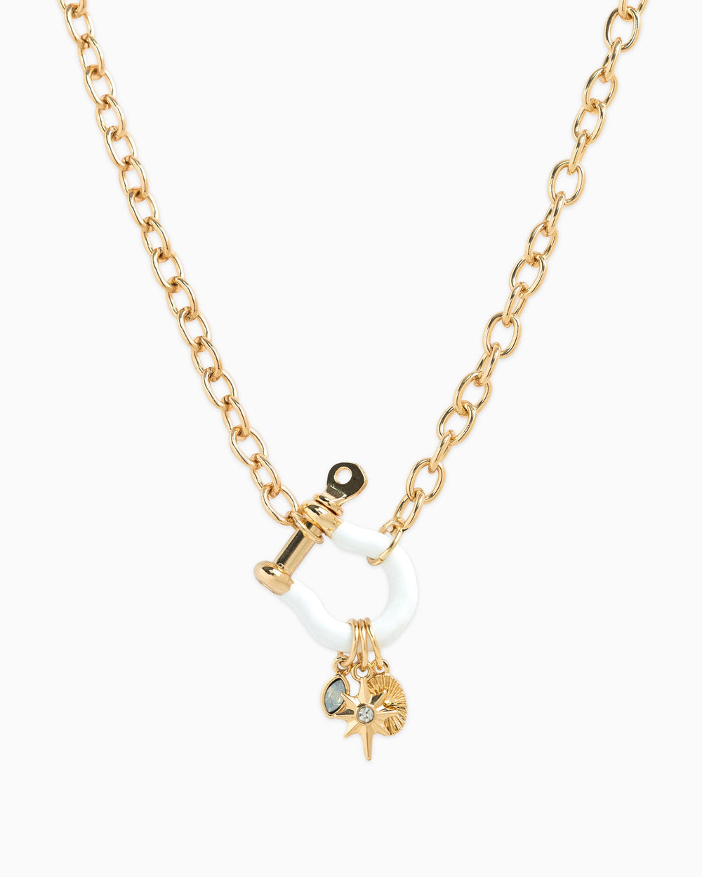 Gold chain necklace with white enamel horsebit carabiner and three dangling star charms