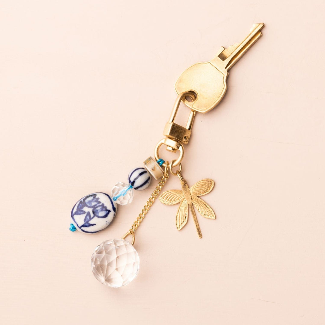 Scout Bookmark Keychain Set featuring blue butterfly ceramic beads, crystal charm, and gold dragonfly pendant