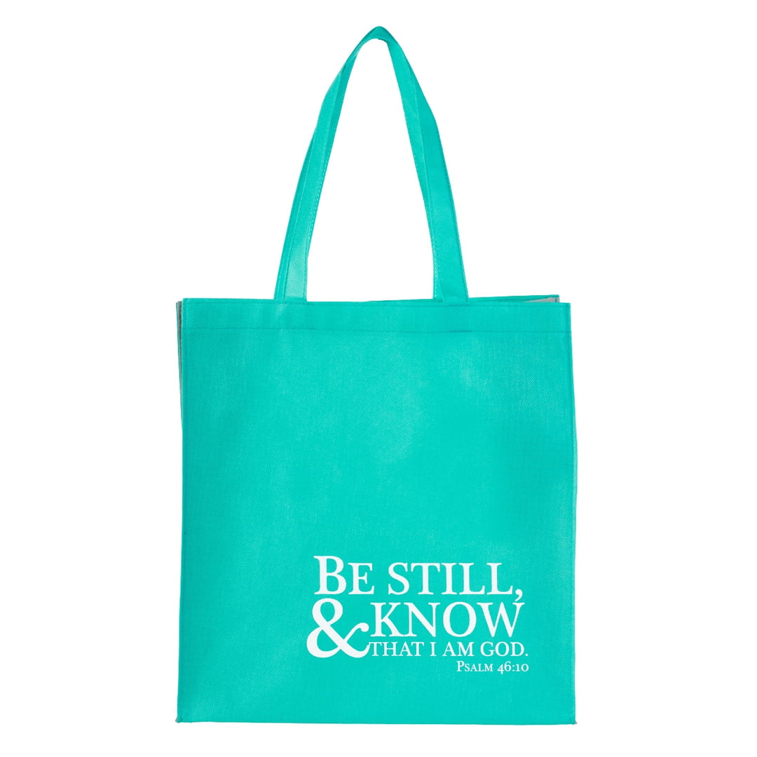 Turquoise tote bag with white text 'Be Still & Know That I Am God Psalm 46:10'