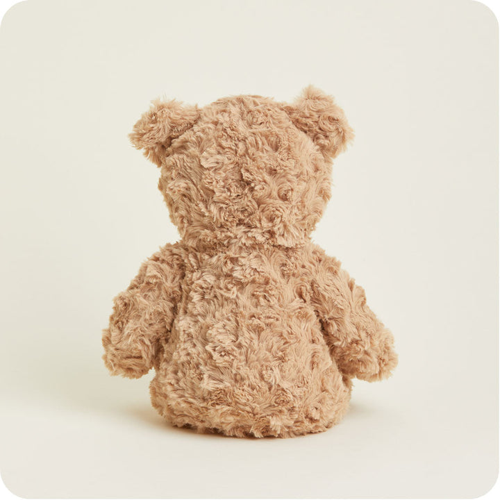Brown curly textured Warmies plush bear against clean white background