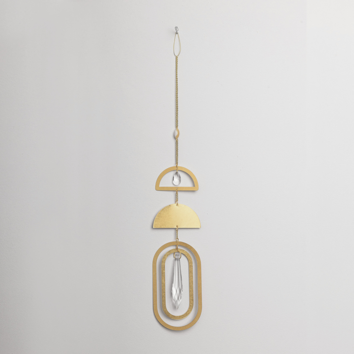 Scout suncatcher with gold geometric shapes and hanging crystal pendant