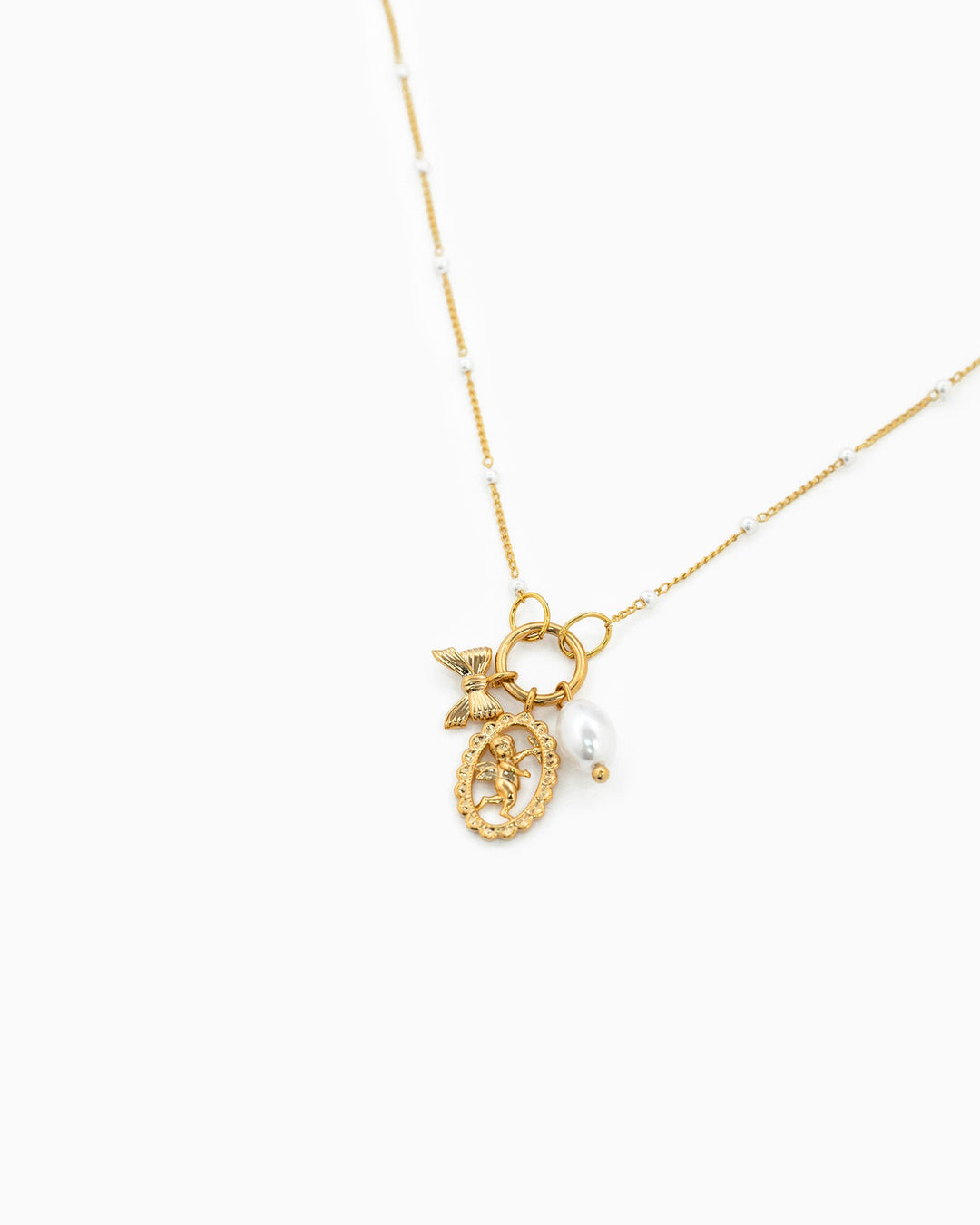 Gold satellite chain necklace featuring cherub medallion charm, bow charm, and white pearl drop