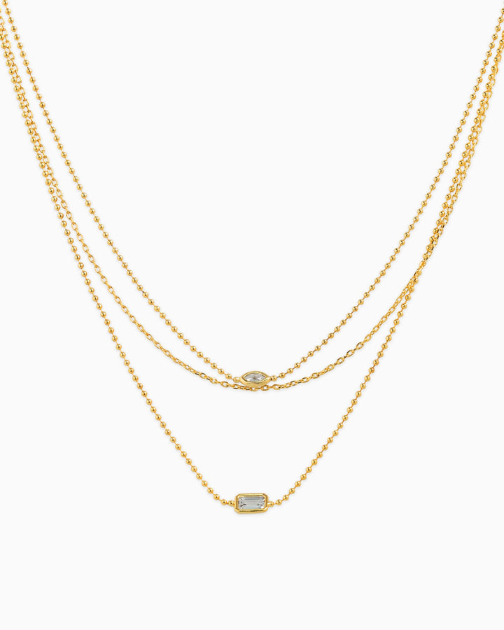 Three-layer gold necklace set featuring marquise and baguette CZ stone pendants on ball chains