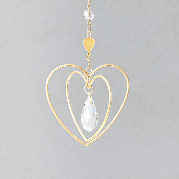 Scout Mini Suncatcher in Sun colorway featuring gold heart frames with hanging crystal