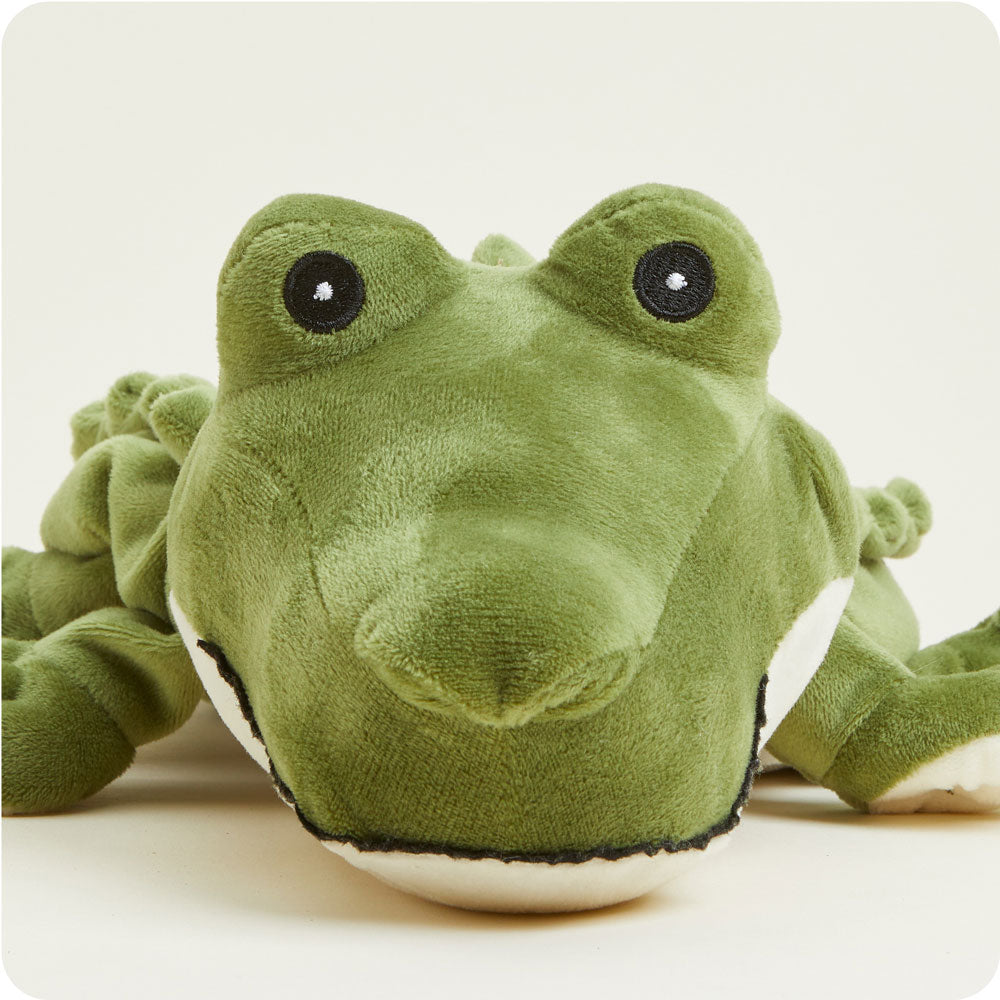 Green Warmies plush alligator stuffed animal with embroidered eyes on white background
