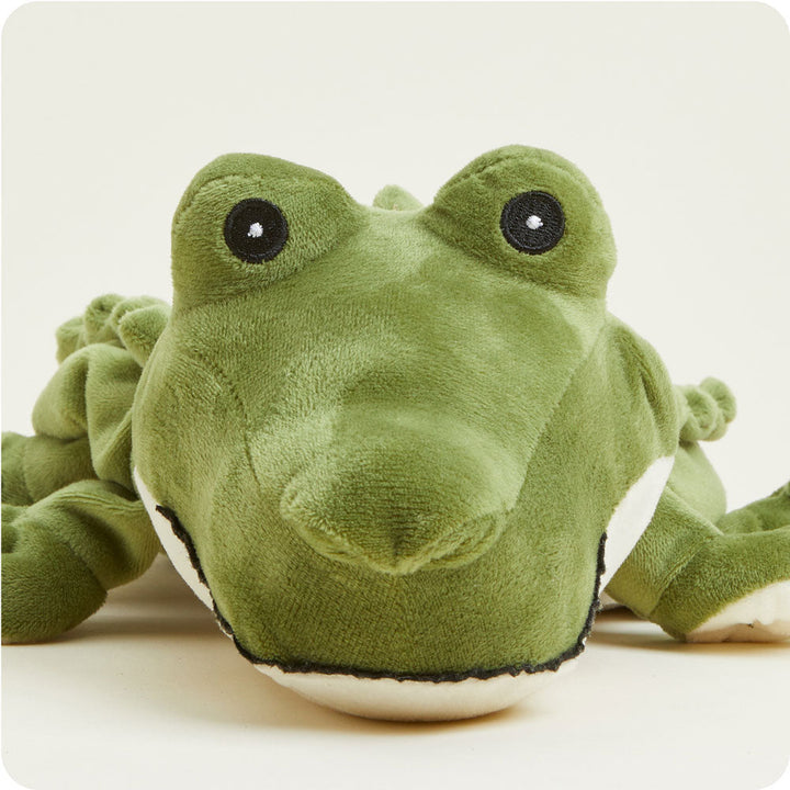 Green Warmies plush alligator stuffed animal with embroidered eyes on white background