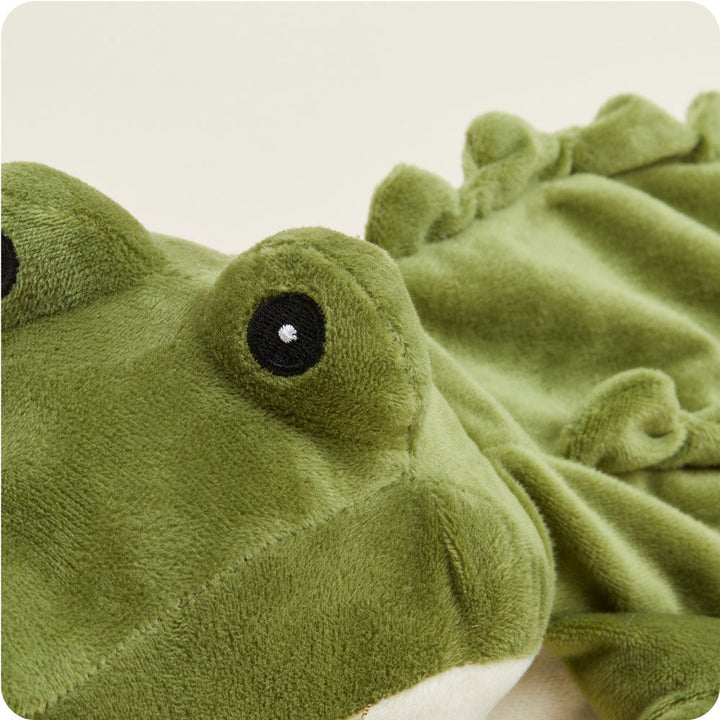 Green alligator Warmies plush toy with black embroidered eye on clean background