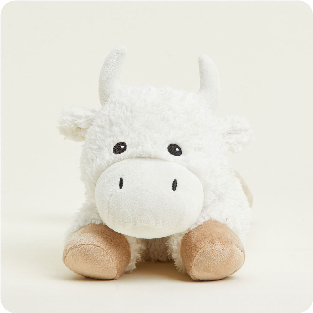 Warmies white plush cow stuffed animal with tan hooves on clean background