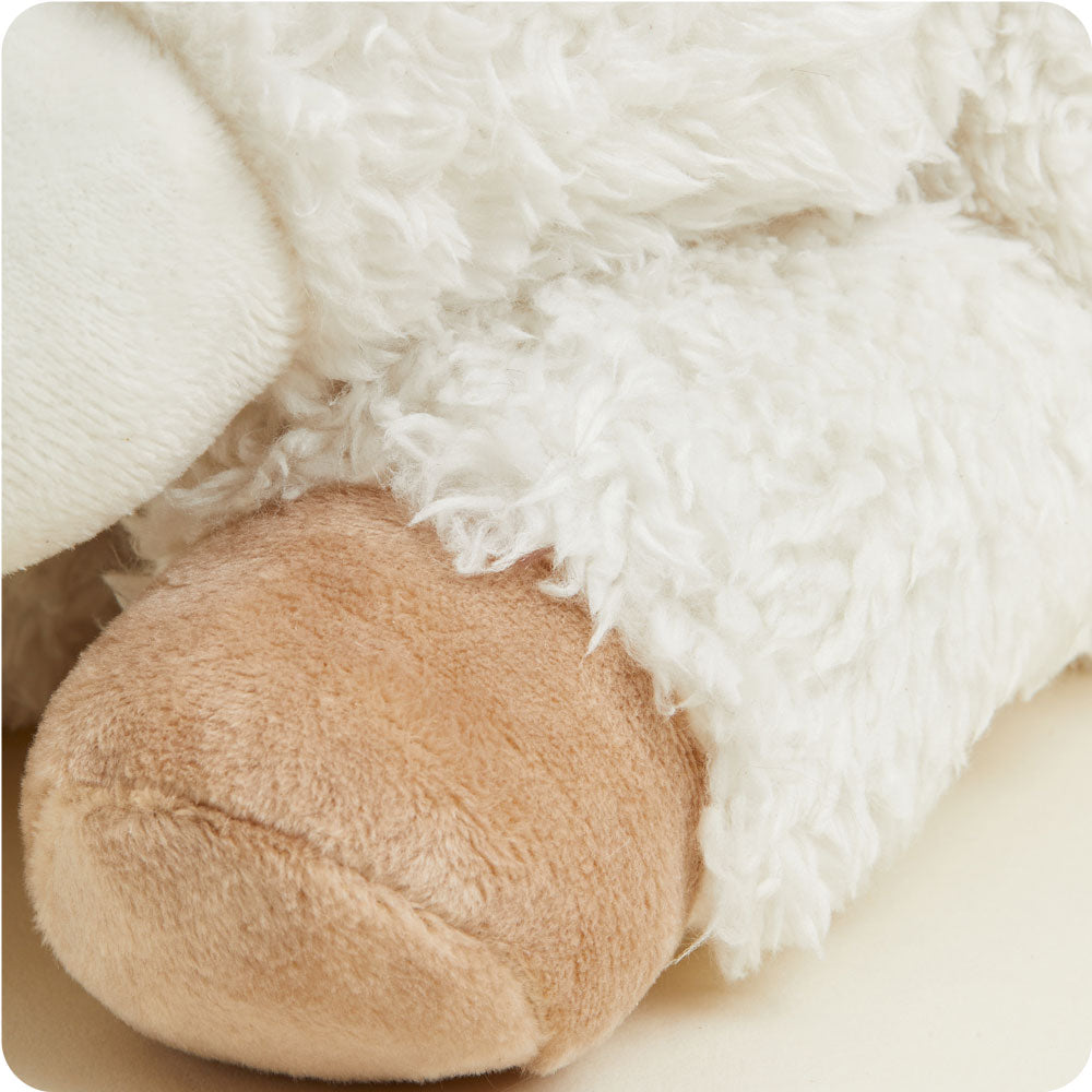 Warmies plush stuffed animal in cream white with brown details, soft textured fabric