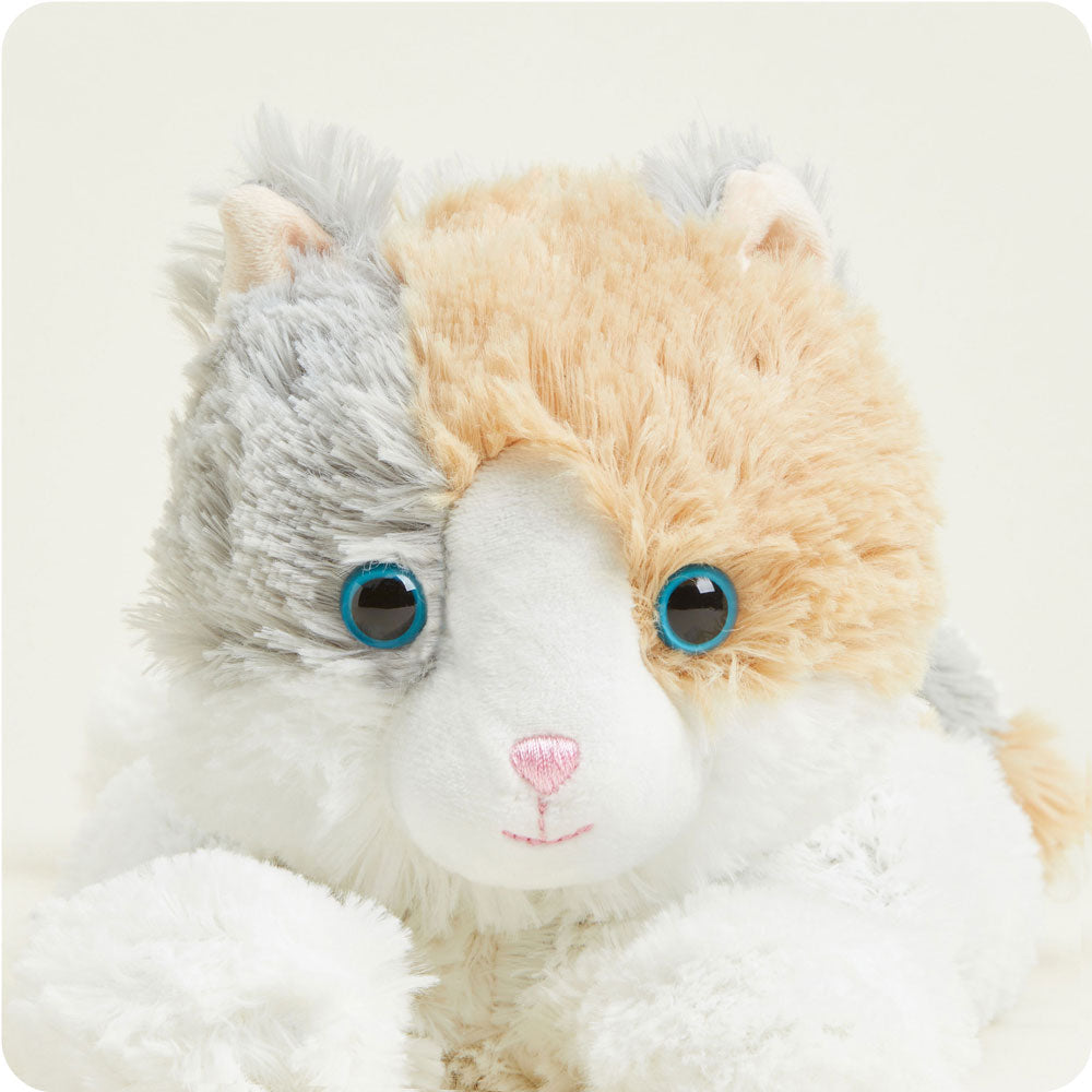 Warmies plush calico cat with blue eyes, white body and orange-gray patches