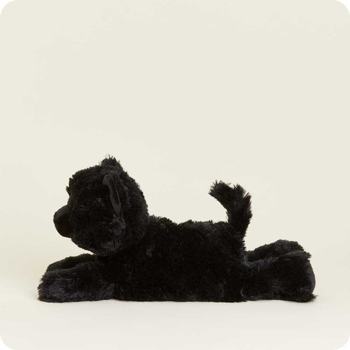 Warmies black cat plush toy lying on side against white background