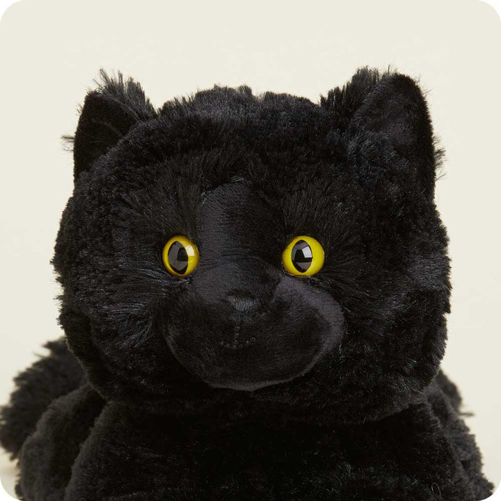 Warmies black cat plush toy with bright yellow eyes and soft fur